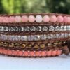 wrap, wraps around wrist, zinc, semiprecious stones, coral, clear, light coral, pink, brass, zinc contemporary button, adjustable, handcrafted, takes 2-4 hours to make, waxed cord, designer inspired
