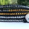 wrap, wraps around wrist, zinc, hematite, gold, heavy metal, hammered button, adjustable, handcrafted, takes 2-4 hours to make, waxed cord, designer inspired, simple, contemporary